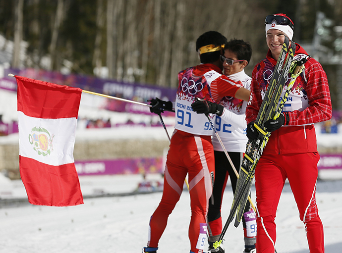 Switzerland's Dario Cologna (R) smiles as Peru's Roberto Carcelen and Nepal's Dachhiri Sherpa (L) embrace after crossing the finish line in the men's cross-country 15km classic event at the 2014 Sochi Winter Olympics February 14, 2014. (Reuters / Stefan Wermuth)