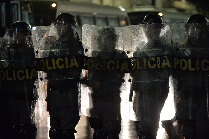 Policemen stand guard during a protest against the government's expenditure for the 2014 FIFA World Cup in Sao Paulo, Brazil on February 22, 2014. (AFP Photo / Nelson Almeida)