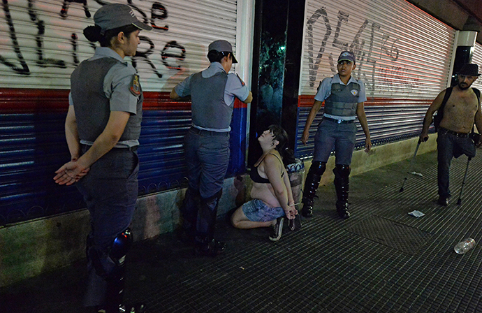 Policewomen arrest a woman during a protest against the government's expenditure for the 2014 FIFA World Cup in Sao Paulo, Brazil on February 22, 2014. (AFP Photo / Nelson Almeida)