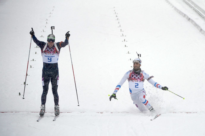 Gold medalist Norway's Emil Hegle Svendsen (9) and Silver medalist France's Martin Fourcade (2) cross the finish line in the Men's Biathlon 15 km Mass Start at the Laura Cross-Country Ski and Biathlon Center during the Sochi Winter Olympics on February 18, 2014, in Rosa Khutor, near Sochi. (AFP Photo / Pierre-Philippe Marcou)