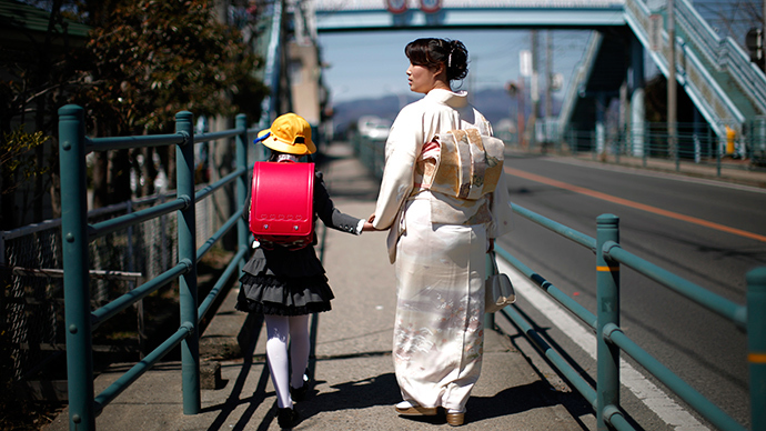 A girl walks with her mother after her first day of school at the Shimizu elementary school in Fukushima, northern Japan (Reuters)