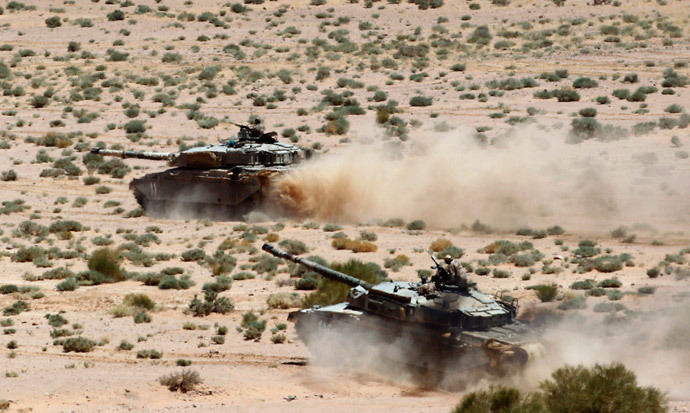 Tanks advance during the Eager Lion military exercise near the southern town of Al Quweira, 50 km (30 miles) from the coastal city of Aqaba June 19, 2013. (Reuters / Muhammad Hamed)