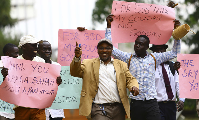 Ugandan anti-gay activist Pastor Martin Ssempa (C) leads anti-gay supporters as they celebrate after Uganda's President Yoweri Museveni signed a law imposing harsh penalties for homosexuality in Kampala February 24, 2014. (Reuters/Edward Echwalu)
