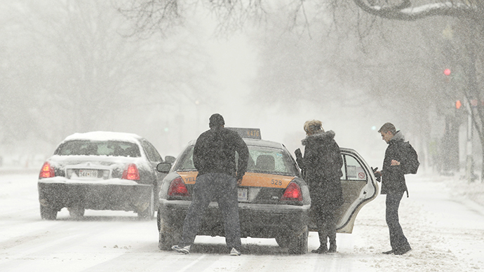 People get into a scarce taxicab during a blizzard in Washington March 3, 2014. (Reuters / Gary Cameron)