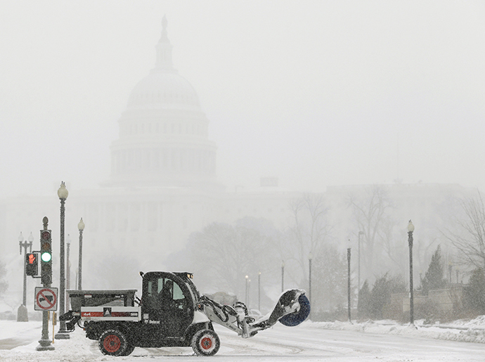 A snow sweeper attempts to keep a street open in front of the U.S. Capitol during a blizzard in Washington March 3, 2014. (Reuters / Gary Cameron)
