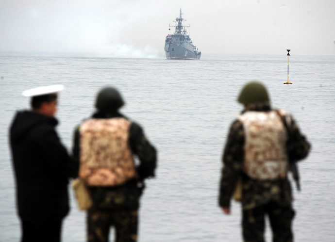 Ukrainian marines look at a Russian ship floating out of the Sevastopol bay on March 4, 2014 (AFP Photo / Viktor Drachev)