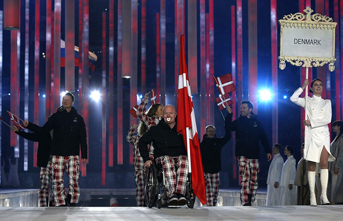 Denmark's flag-bearer Ulrik Nyvold (C), leads his country's contingent during the opening ceremony of the 2014 Paralympic Winter Games in Sochi, March 7, 2014. (Reuters / Alexander Demianchuk)