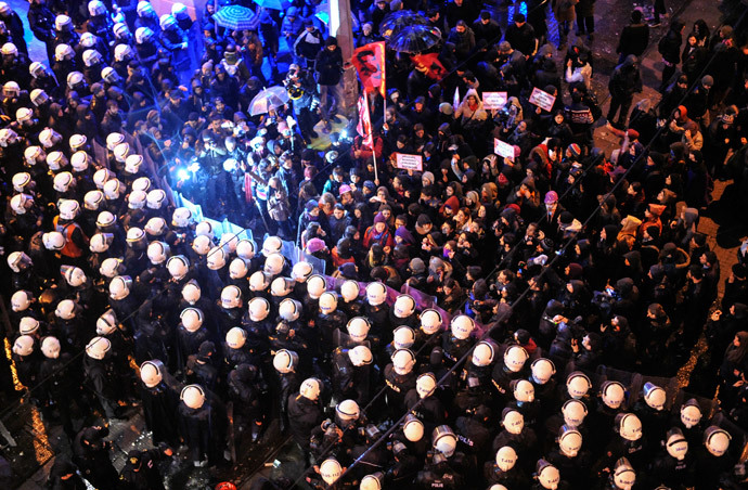 Turkish women are blocked by a barricade of riot policemen as they march towards Taksim square as part of the "International Women's Day" on March 8, 2014, in Istanbul. (AFP Photo / Ozan Kose)