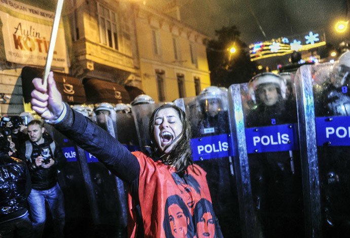 A Turkish woman shouts in front a barricade of riot policemen as she and other protesters march towards Taksim square as part of the "International Women's Day" on March 8, 2014, in Istanbul. (AFP Photo / Ozan Kose)