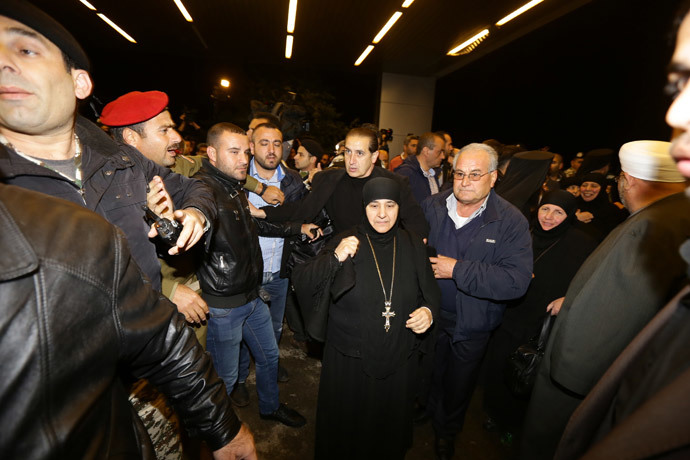Kidnapped nuns arrive at Jdeidet Yabus on the Syrian side of the border with Lebanon after an arduous nine-hour journey that took them from Yabrud into Lebanon, and then back into Syria on March 10, 2014.( AFP Photo / Louai Beshara)