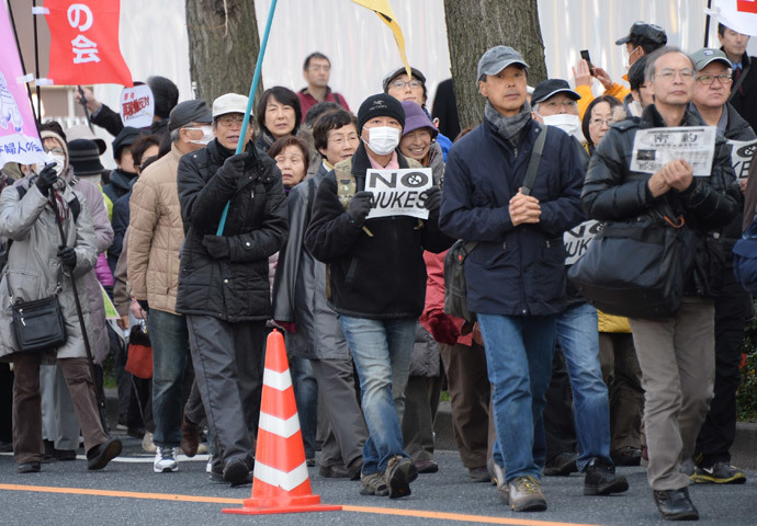 People march down the street toward the official residence of the prime minister and the National Diet during an anti-nuclear power plant demonstration in Tokyo on March 9, 2014.(AFP Photo / Toru Yamanaka)