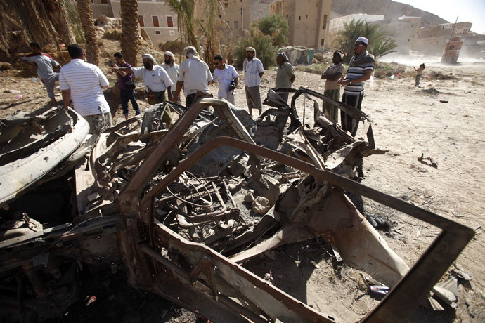 People talk to human rights activists next to debris left by a U.S. drone air strike that targeted suspected al Qaeda militants in August 2012, in the al-Qatn district of the southeastern Yemeni province of Hadhramout February 5, 2013. (Reters / Khaled Abdullah)