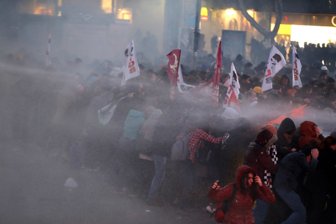 Anti-government protesters run as riot police fires a water cannon during a demonstration in Ankara March 11, 2014. (Reuters)