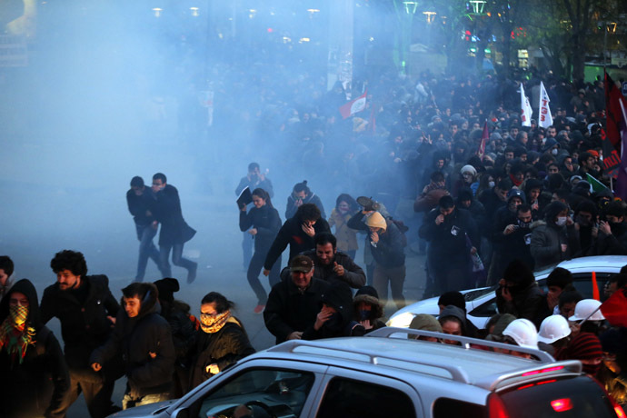 Anti-government protesters run as riot police fires tear gas during a demonstration in Ankara March 11, 2014. (Reuters)