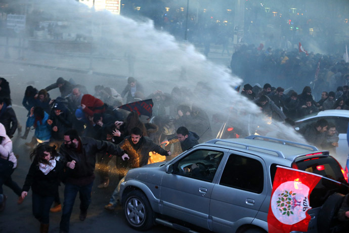 Anti-government protesters run as riot police fires a water cannon during a demonstration in Ankara March 11, 2014. (Reuters)