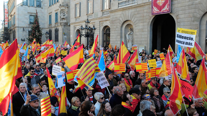 Catalans against the region's independence hold a Spanish flag during a demonstration for the unity of Spain and against the independence of Catalonia marking the Spanish constitution Day in Barcelona on December 6, 2013.(AFP Photo/ Josep Lago)
