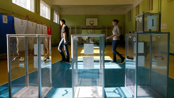 Election commission officials take part in the preparations for a referendum at the polling station in the Crimean town of Simferopol March 15, 2014. (Reuters / Vasily Fedosenko)