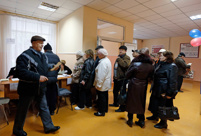 People line up to receive their ballots during the referendum on the status of Ukraine's Crimea region at a polling station in Simferopol March 16, 2014. (Reuters / Vasily Fedosenko)