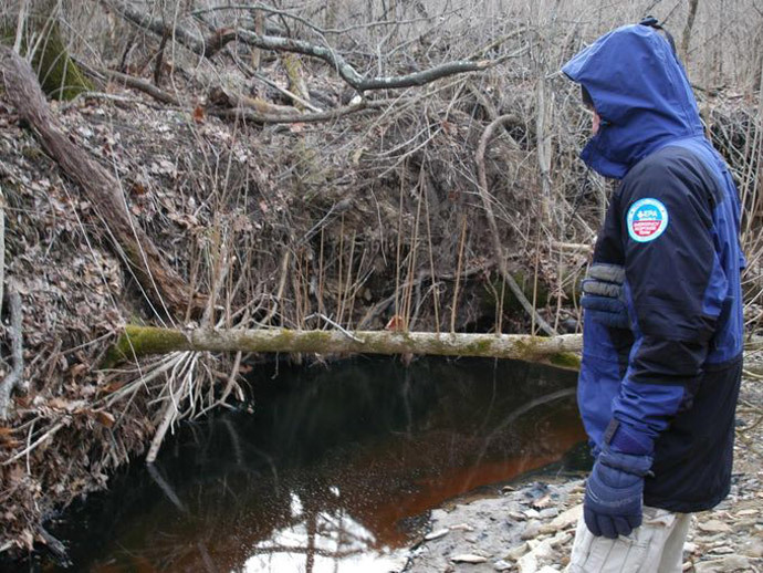 Crude oil pools in a stream near the site of the pipeline leak. (Provided / EPA)