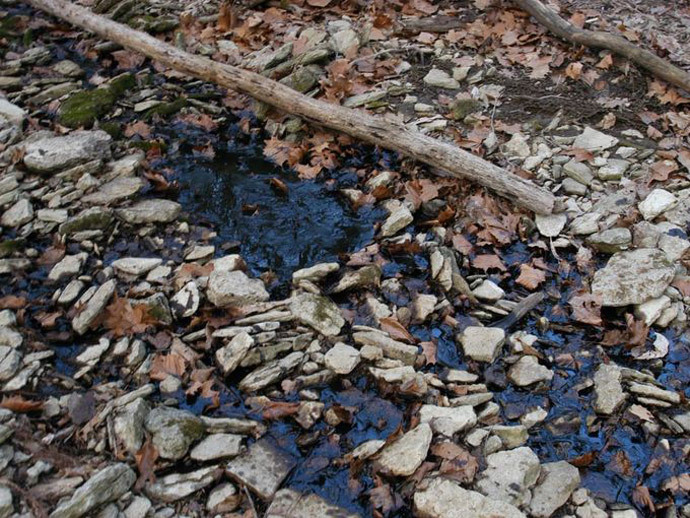 Crude oil discharges from a stream to a lake near the site of the spill. (Provided / EPA)