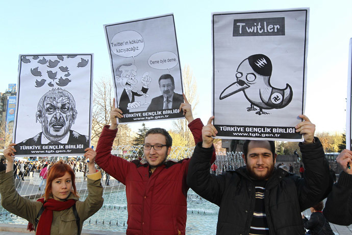 People hold placards as they protest against Turkey's Prime Minister Tayyip Erdogan after the government blocked access to Twitter in Ankara, on March 21, 2014. (AFP Photo/Adem Altan)