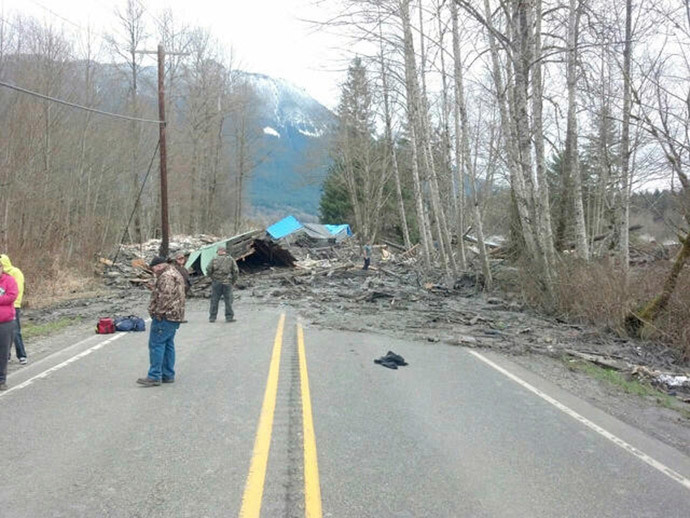 Officials survey a large mudslide in this handout photo provided by the Washington State Police near Oso, Washington March 22, 2014. (Reuters / Washington State Police / Handout via Reuters)