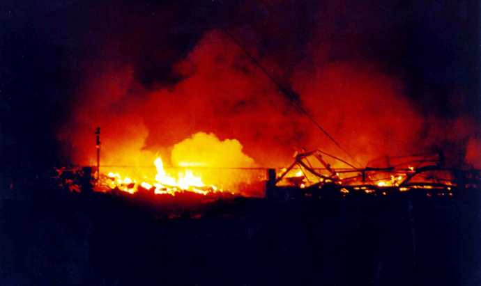 A police training centre in Novi Sad, in the north of Yugoslavia burns 25 March 1999 after it was destroyed during NATO air strikes, according to the official Yugoslav news agency, Tanjug (AFP Photo)