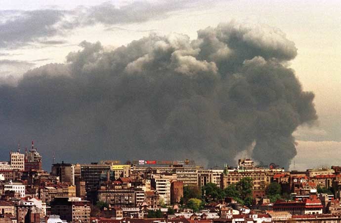 Smoke looms over Belgrade from the Pancevo chemical plant after NATO air strike April 18. (Reuters)