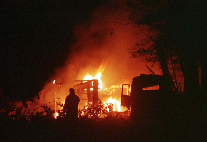 Vehicles burn outside a hospital in Belgrade after NATO air strikes May 20. (Reuters)