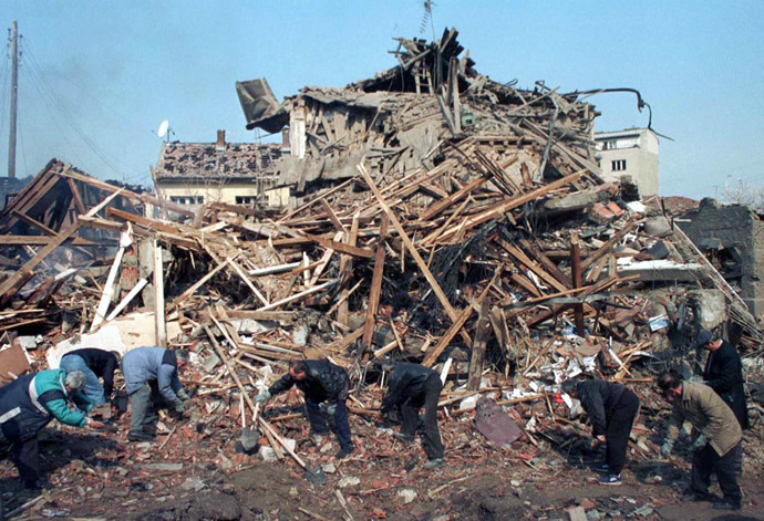 Pristina residents search through the rubble after a NATO missile hits the centre of Kosovo's capital early April 7. (Reuters)