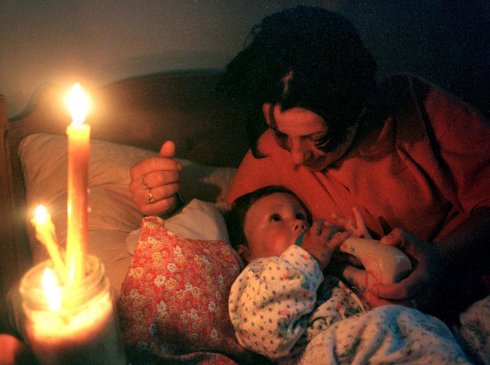 A woman feeds her baby in a Belgrade bomb shelter after air raid sirens went of May 8. (Reuters)