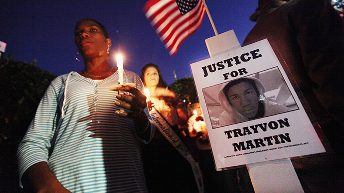 Supporters gather during a candelight vigil at a memorial to Trayvon Martin outside The Retreat at Twin Lakes community where Trayvon was shot and killed by George Michael Zimmerman while on neighborhood watch patrol on March 25, 2012 in Sanford, Florida. (AFP Photo / Mario Tama)