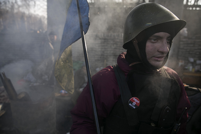 A member of the Right Sector movement guards a barricade in central Kiev (Reuters / Baz Ratner)