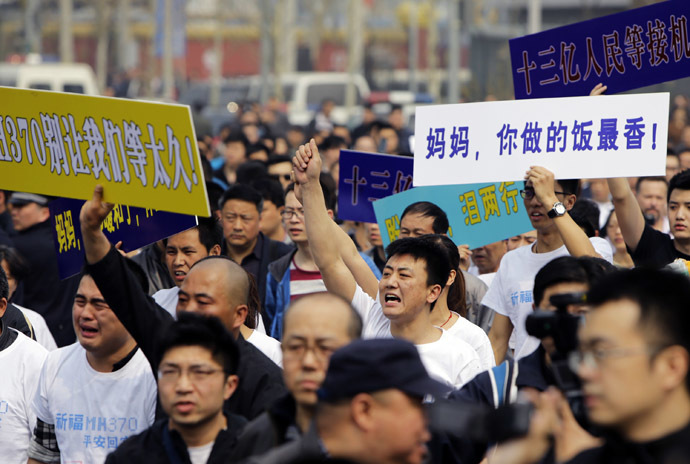 Family members of passengers aboard Malaysia Airlines MH370 shout slogans during a protest near the Malaysian embassy in Beijing, March 25, 2014. (Reuters/Jason Lee)