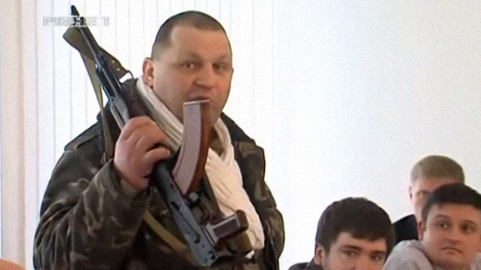 Ukrainian nationalist Muzychko armed with AK-47 threatens Rovno regional parliament on February 26, 2014.