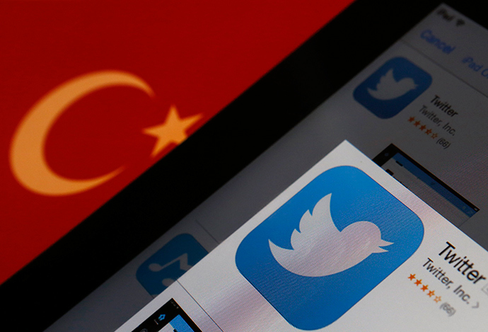 A Twitter logo on an iPad display is pictured next to a Turkish flag in this photo illustration taken in Istanbul March 21, 2014 (Reuters / Murad Sezer)