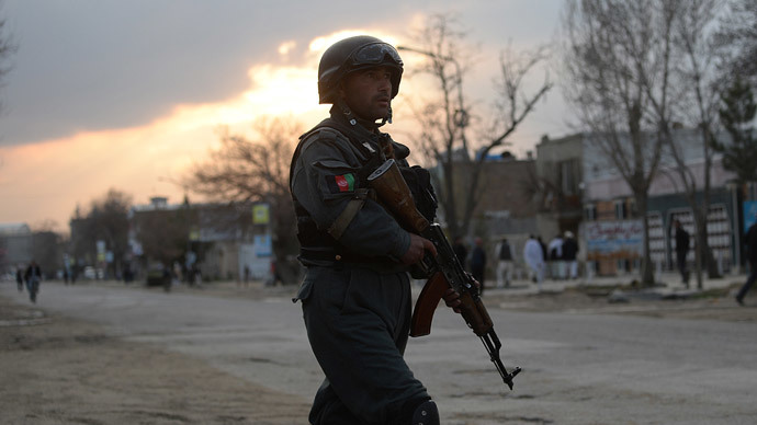 An Afghan policeman stands guard near a guesthouse attack by Taliban fighters in Kabul on March 28, 2014.(AFP Photo / Shah Marai)
