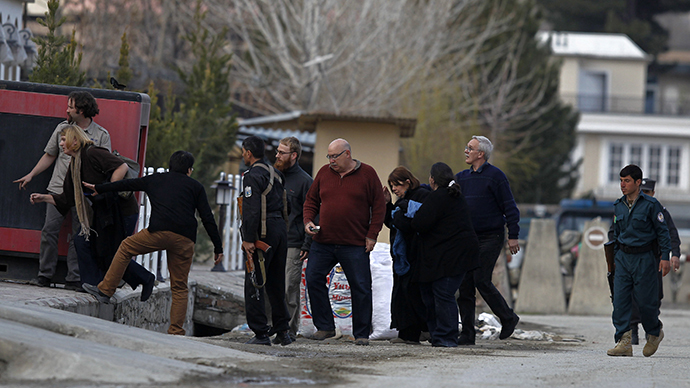 An Afghan policeman evacuates foreigners from the site of an attack in Kabul March, 28, 2014. (Reuters / Omar Sobhani)