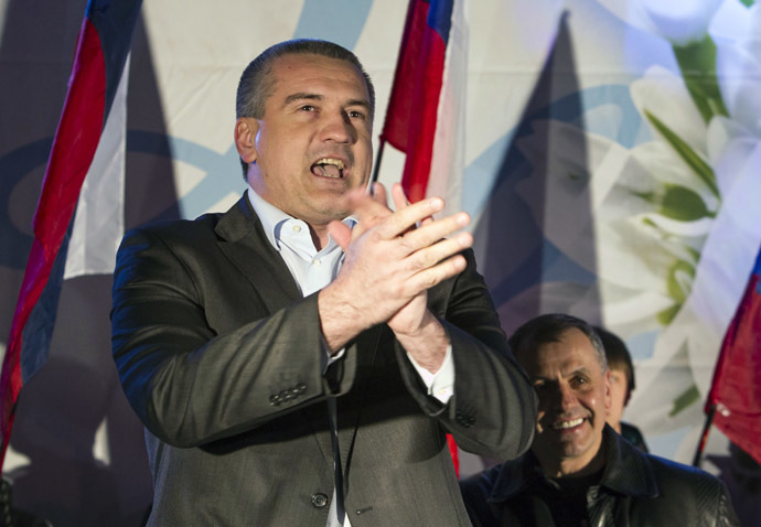 Crimea's Prime Minister Sergei Aksyonov (L) and parliamentary speaker Vladimir Konstantinov celebrate the time shift in the Crimean city of Simferopol March 30, 2014. (Reuters/Shamil Zhumatov)