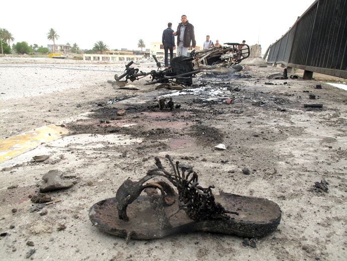 A bloodied slippers and a destroyed motor bike are seen following a suicide bombing along the center of the al-Hauz Bridge which lies across the Euphrates River linking the southern district with the central and northern district of the city of Ramadi, west of the capital Baghdad on March 30, 2014 (AFP Photo)