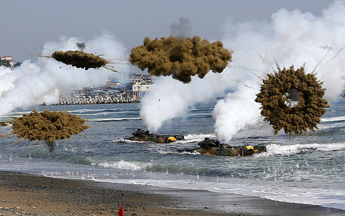 Amphibious assault vehicles of the South Korean Marine Corps throw smoke bombs as they move to land on shore during a U.S.-South Korea joint landing operation drill in Pohang March 31, 2014. (Reuters/Kim Hong-Ji)