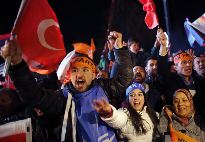 Supporters of the ruling AK Party wave Turkish flags as they wait for the arrival of Turkish Prime Minister Tayyip Erdogan at the party's headquarters in Ankara March 30, 2014. (Reuters/Umit Bektas)