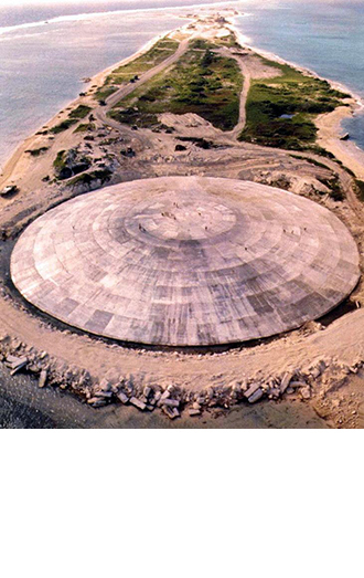(FILES) Picture taken by the US Defense Nuclear Agency in 1980, shows the huge dome, which has just been completed over top of a crater left by one of the 43 nuclear blasts on the island, expected to last 25,000 years, capping off radioactive debris from nuclear tests over Runit Island in Enewetak in the Marshall Islands. (AFP Photo / Giff Johnson)
