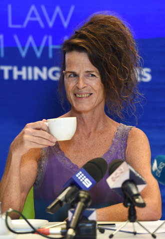 Norrie, who uses only a first name and does not identify as either male or female, has a cup of tea during a press conference in Sydney on April 2, 2014. (AFP Photo / William West)