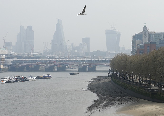 A seagull flies above the skyline of the City of London April 2, 2014. (Reuters / Olivia Harris)