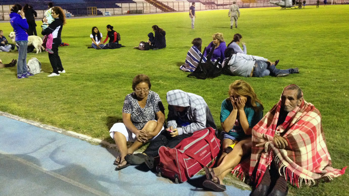 Locals take refuge at the city stadium following a tsunami alert after a powerful 8.0-magnitude earthquake hit off Chile's Pacific coast, on April 1, 2014 in Iquique. (AFP Photo / Aldo Solimano)