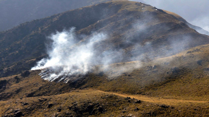 Smoke rising apparently after a cross-border NATO air strike on Pakistani border posts on a mountain in the Mohmand tribal district, on November 26, 2011.(AFP Photo / ISPR) 