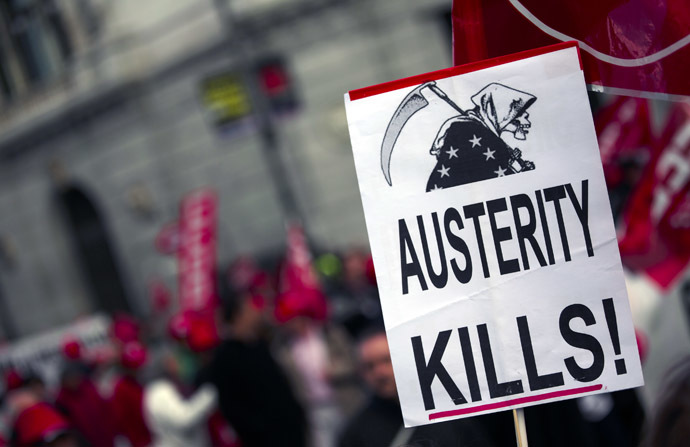 A placard held by a protester is seen during a demonstration against European and Spanish austerity measures in Madrid April 3, 2014. (Reuters/Sergio Perez)