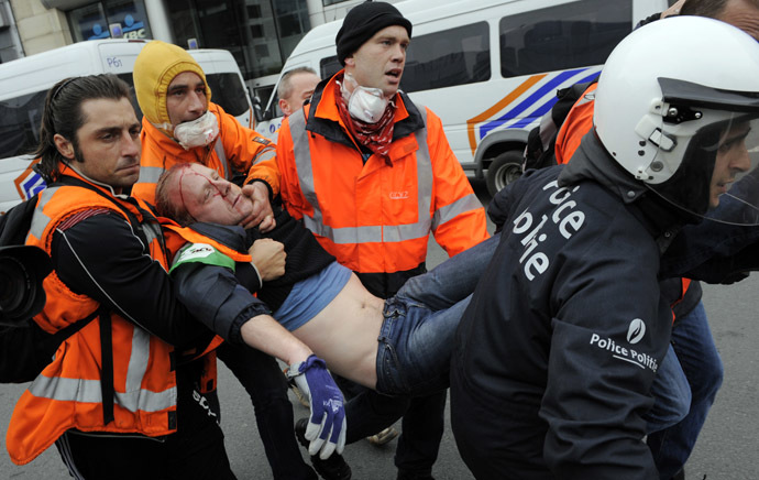 Rescue workers and police evacuate a protestor who was injured during clashes at the end of a demonstration by tens of thousandspeople in the European district of Brussels to denounce the austerity measures in Europe on April 4, 2014 in Brussels. (AFP Photo)