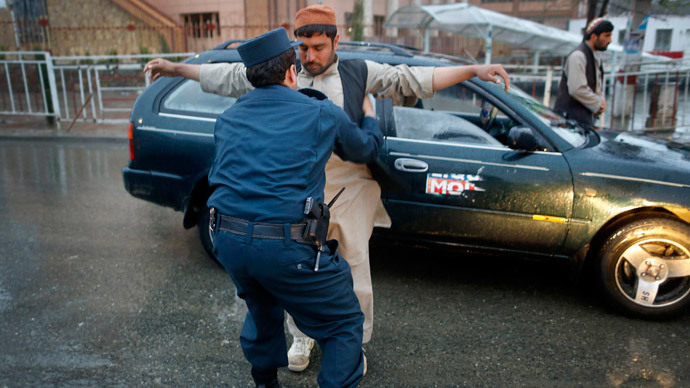 A policeman checks a motorist at a road block on election day in central Kabul April 5, 2014.(Reuters / Tim Wimborne)